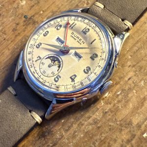 Ceas vintage Buren Grand Prix elvețian, triple date și fazele lunii, anii ’40–’50, funcțional, rar de găsit – sertar