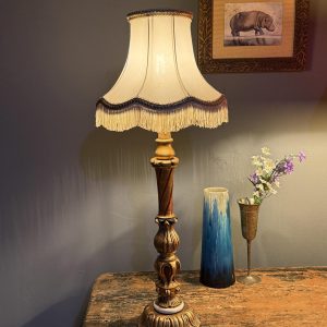 Lampă de masă cu picior vechi din lemn sculptat și policrom, recondiționată cu instalație electrică nouă și abajur textil cu franjuri. Sertar Magic București.